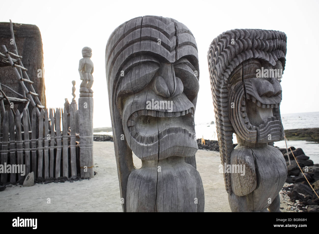 Tiki statues with big expressions at the Pu`uhonua o Honaunau (place of refuge) on the Big Island in Hawaii Stock Photo